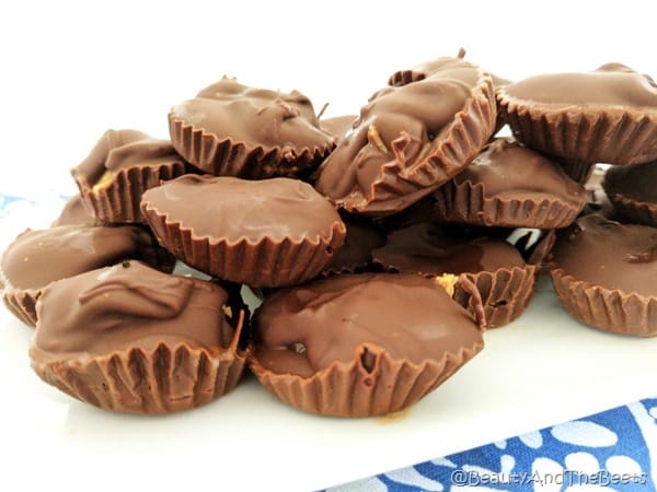 A disorganized pile of peanut butter cups on a white plate with a white background