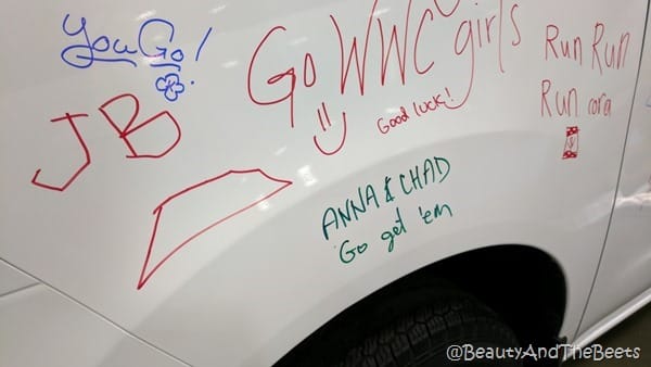 A white SUV with writing on it containing the words anna and chad go get 'em in green 