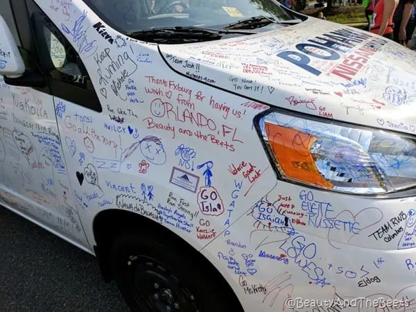 a white SUV with lots of writing on it including the words Beauty and the Beets
