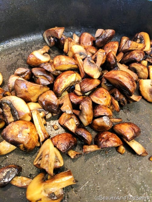 a cast iron pan of sauteed mushrooms and ginger