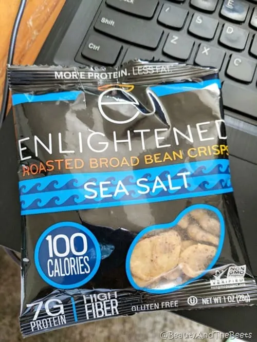 A black and blue colored bag of Enlightened Bean crisps on a laptop keyboard for Friday Favorites