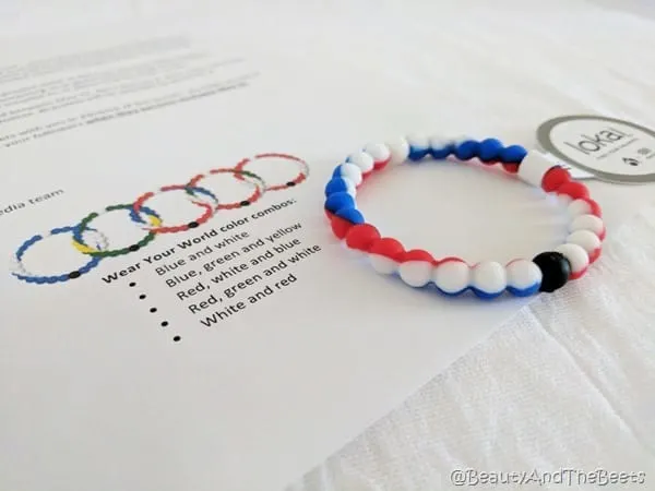 a red white and blue bead bracelet on a piece of paper with pictures of the other bracelets