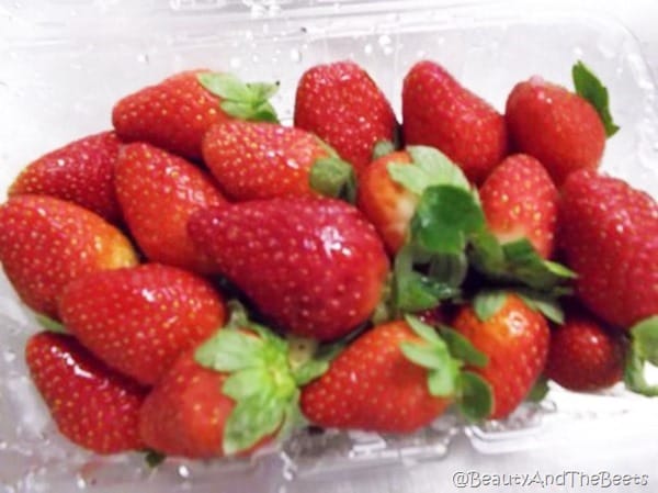 a small pile of red strawberries on a white background