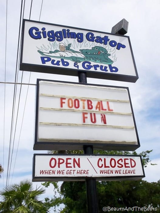 the marquee of the giggling gator pub sign reading open when we get here and closed when we leave