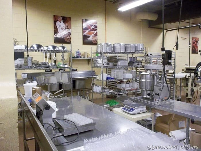 the stainless steel kitchen with shelves of bowls and baking sheets at Whetstone Chocolates