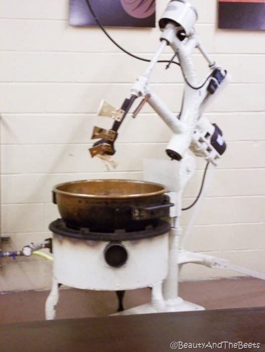 a white and copper industrial mixer on the factory floor