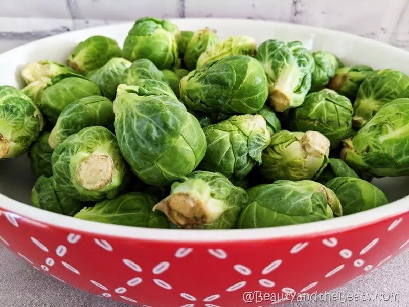 Brussels sprouts in red bowl Beauty and the Beets