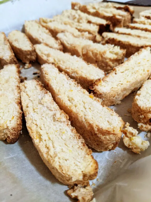 A baking tray of lightly toasted biscotti slices