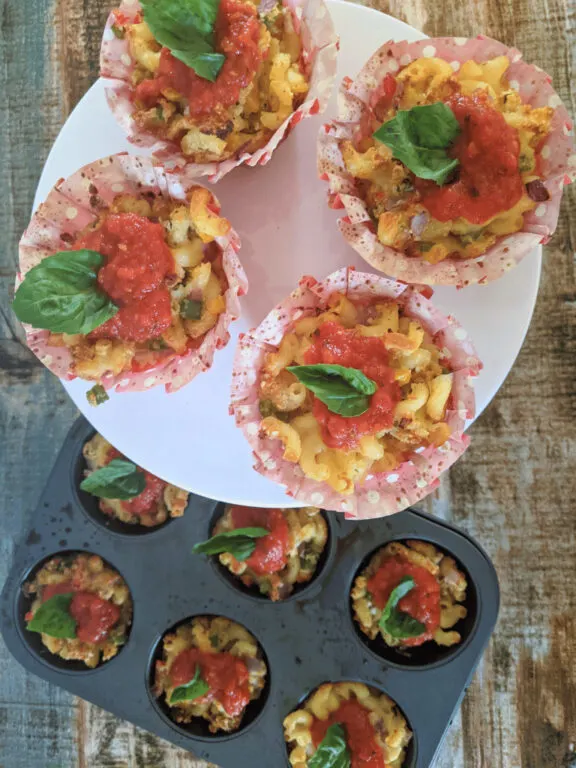 pizza mac and cheese bites in cupcake liners with basil